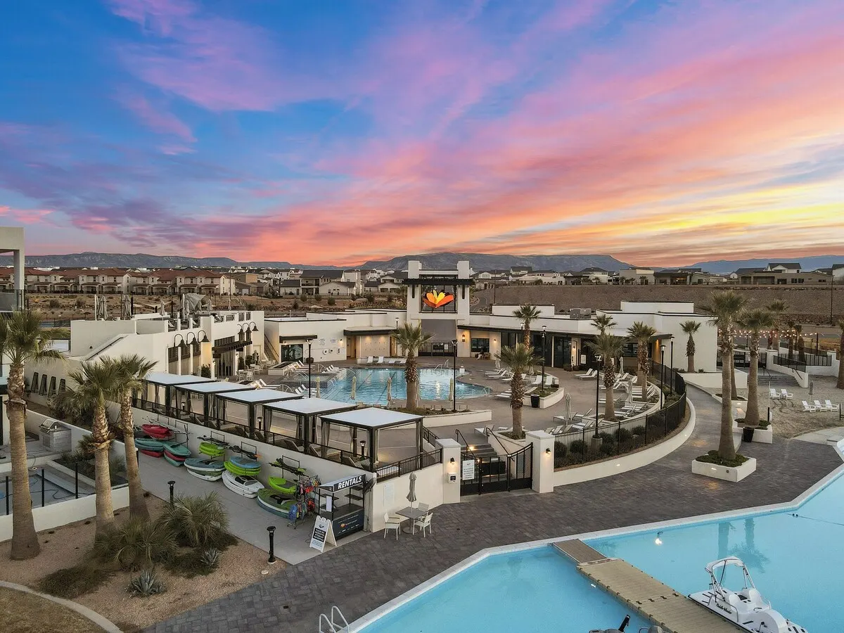 Clubhouse pool with cabanas and paddleboard rentals at sunset