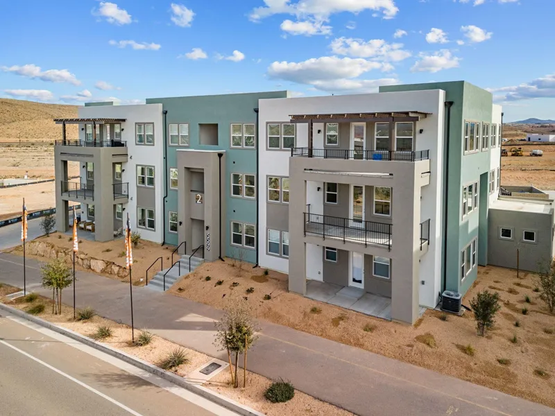 Three-story Holmes condo building with balconies and pergolas in Desert Color