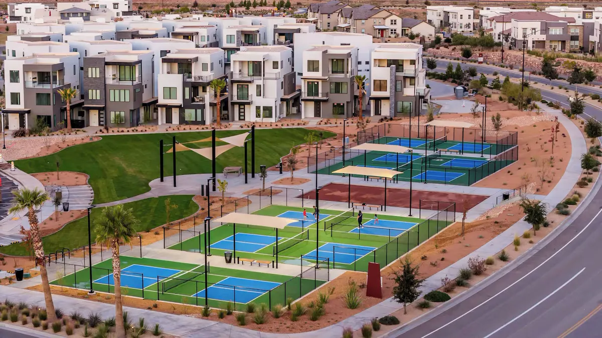 Pickleball courts with shade structures next to a park