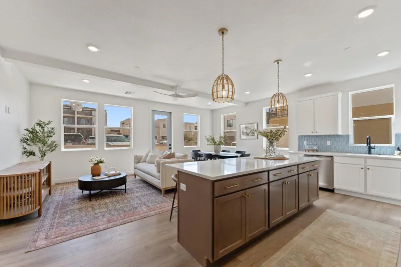 Bright condo living room and kitchen with a large island and pendant lights in a Holmes nightly rental